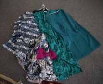Assorted 1970s and 1980s vintage womens' wear in shades of teal and navy with red and pink