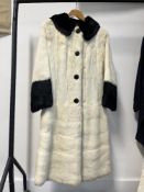 A stylish 1960s long fur coat in extremely fine, silky soft cream fur with contrasting black flat