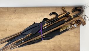 A collection of 20th century vintage umberellas to include wood, bamboo, leather and perspex