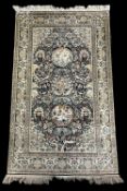 A 20th century Sino-Persian pictorial hand-knotted silk rug, having three central medallion