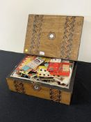 An antique sewing box with intricate chevron work and hexagonal mother of pearl medallions