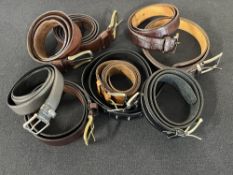 Nine vintage men's leather belts in various styles, shade of black, grey and brown to include St.