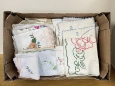 Assorted vintage tablecloths and place settings with scalloped edge and various colourful embroidery
