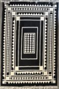 A 20th century vintage hand knotted flat-weave large area rug in black and cream gemoetric