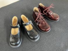 Two pairs of Babybotte patent shoes, comprising black Mary Janes and burgundy lace-up boots, both in