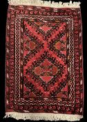 A 20th century vintage hand knotted wool Baluch or tribal rug with asymmetric central diamond design