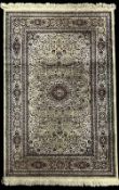A 20th century Persian style wool rug having a sage ground, midnight navy and maroon accents,