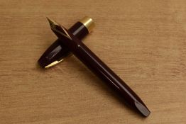 A Sheaffer Pen For Men III Snorkel fill fountain pen in Burgundy with gold trim having Sheaffer