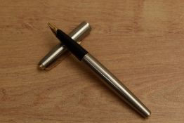 A Parker 65 Flighter converter fill fountain pen with gold trim with Parker 14K 585 England nib.