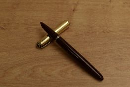 A Parker 51 vacumatic fill fountain pen in Cordovan Brown with Gold fill converging line cap.