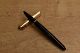 A Parker 51 aerometric fill fountain pen in Black with Gold Fill converging line cap. Circa 1950