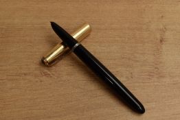 A Parker 51 aerometric fill fountain pen in Black with gold filled converging line cap. Circa 1950