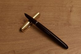 A Parker 51 aerometric fill fountain pen in Burgundy with Gold Fill converging line cap. Circa 1950