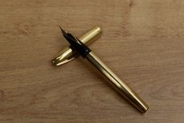 A Sheaffer Triumph Touchdown fill fountain pen in Gold Fill having Sheaffer's 14K nib. Circa 1973.