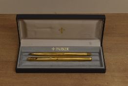 A boxed Parker Classic pencil and ballpoint pen in gold plate vertical line design. Circa 1990