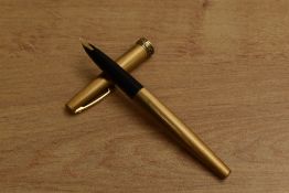 A Sheaffer Crest Lady converter fill fountain pen in gold colour with snail trail cap band. Circa