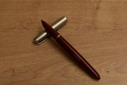A Parker 21 Standard MkI aerometric fill fountain pen in Red with brushed steel cap. Circa 1949. A