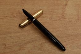 A Parker 51 Aerometric fill fountain pen in Black with gold filled parallel lined cap. Circa 1954