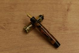 A Parker Duofold Streamlined Vest Pocket button fill fountain pen in Pearl and Black with three