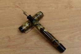 An AGDCR button fill fountain pen in Brown marble with two cap bands having AGDCR H 4 nib. From