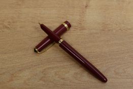 A Conway 106 aero fill fountain pen in red with single cap band. Circa 1950