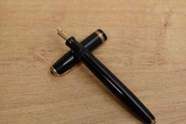 A Parker Duofold button fill fountain pen with single cap band having Parker 14K England 35 nib.