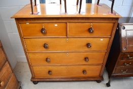A Victorian golden oak chest of two over three drawers having turned rosewood handles and bun