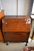 An early 20th Century mahogany bureau having drop flap with fitted interior, applique decoration,