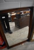 A modern mahogany effect wall mirror , approx. 85 x 59cm