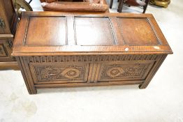 A nice quality reproduction oak bedding chairs having mythical beast carvings to the two front