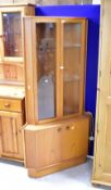 A vintage teak corner display with double cupboard to base, height approx. 170cm