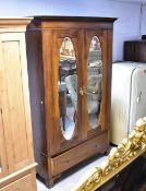 An Edwardian mahogany bedroom suite comprising mirror door wardrobe, dressing table and washstand