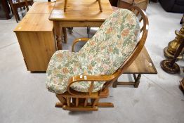 A traditional oak framed 'to and fro' rocking chair