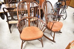 A pair of dark stained Ercol rocking chairs