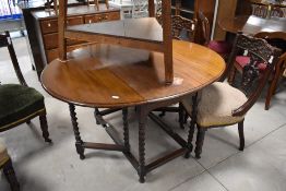 A late 19th or early 20th Century mahogany table having oval top with twist gatelegs and supports,