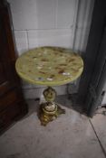 An Onyx effect occasional table having circular top, diameter approx. 41cm, height 54cm