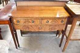 A reproduction Regency sideboard having two short and one long concealed drawer with square