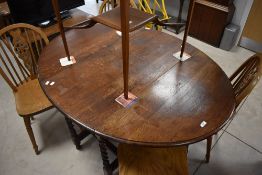 An early to mid 20th Century oak twist gate leg dining table having oval top