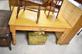 A traditional pine kitchen table having drawer to side and turned legs, approx. 137 x 79cm