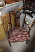 An early 20th mahogany carver chair having feathered back and overstuffed seat