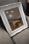 A modern wall mirror having white foliate frame, approx. 53 x 44cm