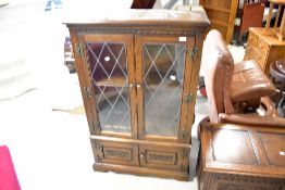 A reproduction Old Charm style bookcase with cupboard under, dimensions approx. W80 D28 H128cm