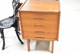 A vintage teak chest of four drawers having semi concealed handles, dimensions approx. Width 59