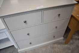 A modern off white bedroom chest of two over two drawers, dimensions approx. W97 D47 H87cm