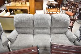 A modern three piece lounge suite comprising three seater sette, electric and manual recliner