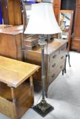 A modern standard lamp in the classical style having heavy base and corinthian column