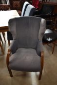 An Art Deco oak wing back chair of small proportions having later blue dralon upholstery, width