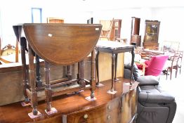 A reproduction mahogany gateleg dining table and a single occasional table (ex nest)