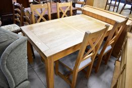 A modern golden oak dining table and four similar chairs having upholstered seats, approx. 150 x