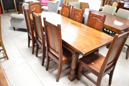 A nice quality reproduction oak refectory style dining table and set of eight similar chairs with